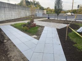 Commercial landscaping project featuring newly installed stone pathways, surrounding greenery, and a neatly maintained outdoor space by McLeod Landscaping.